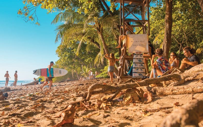 Tourists on the main strip of Santa Teresa on south coast of the