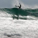 young tico surfer catching a wave